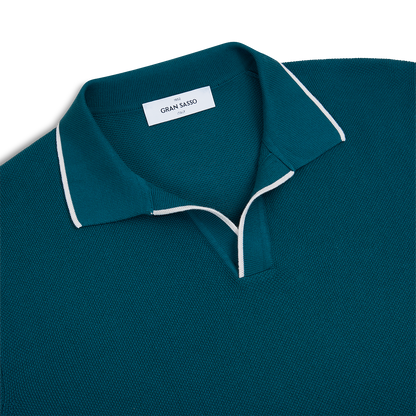 The Gran Sasso Bottle Green Cotton Capri Collar Polo features a white accent stripe, capri collar, short V-shaped placket with no buttons, and a visible brand label inside the neckline. Set against a plain white background. , available at Richard Gelding Mayfair