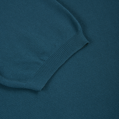 A close-up of the Gran Sasso Bottle Green Cotton Capri Collar Polo showcases the ribbed cuff lying flat against the body, highlighting the fine knit pattern and fabric texture. , available at Richard Gelding Mayfair