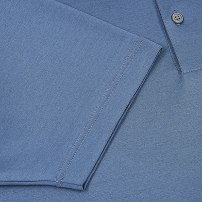 Close-up of the Gran Sasso Blueberry Navy Filo Scozia Polo highlighting the sleeve hem, shirt body, and a gray button on the placket. The filo scozia fabric displays a soft, slightly heathered texture. , available at Richard Gelding Mayfair