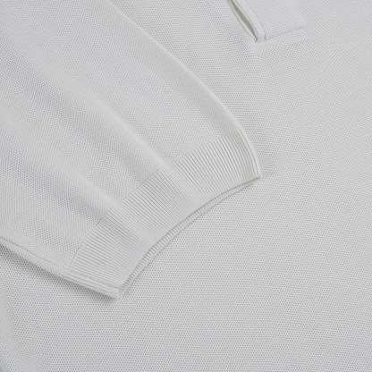 Close-up of the Gran Sasso White Silk Pique Polo, highlighting the soft, fine textured knit fabric and ribbed cuff on the long sleeve. The material features uniform, small bumps throughout for a refined look. , available at Richard Gelding Mayfair