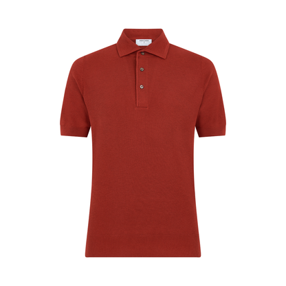 The Gran Sasso Rust Red Silk Pique Polo features short sleeves, a classic collar, three-button placket, and ribbed cuffs and hem, shown against a plain white background. , available at Richard Gelding Mayfair
