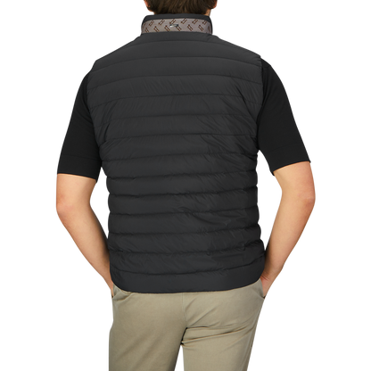 The back view of a man wearing an Italian Herno Black Nylon Goose Down Quilted Gilet.