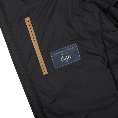 The back of a Black Nylon Goose Down Quilted Gilet with a label on it from the Italian outerwear brand, Herno.