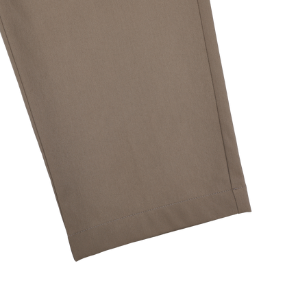Close-up of dark beige nylon stretch drawstring trousers by Herno on a black background, showcasing hem and seam details for craftsmanship enthusiasts.