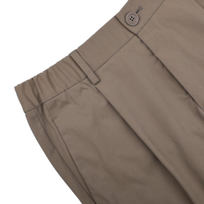 Herno's dark beige nylon stretch drawstring trousers in a slim fit are presented from the side against a black background.