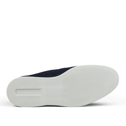A pair of Herno Dark Blue Suede Slip-on Loafers with white soles, viewed from the bottom.