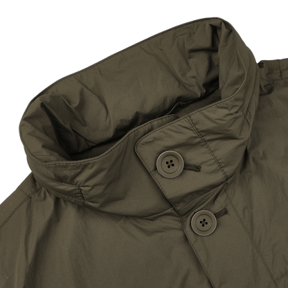 The Herno Dark Green Ultralight Nylon Field Jacket, with a high collar and two visible buttons, offers superior wind and rain resistance.
