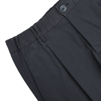 Close-up of Herno's Navy Blue Nylon Stretch Drawstring Trousers with an elastic waistband, side pocket, and visible black button.