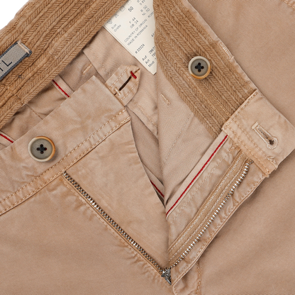Close-up of Hiltl's Beige Washed Cotton Gabardine Slim Chinos, highlighting the zipper, buttons, and interior labels, crafted from premium materials.