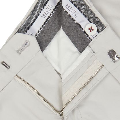 Close-up view of Cream Beige Cotton Nylon Slim Chinos by Hiltl with zipper details and a branded inner lining.