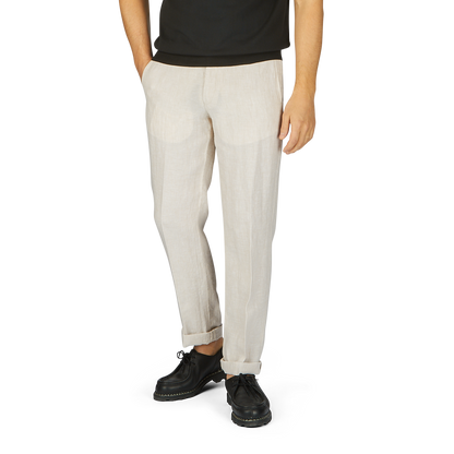 Man wearing Hiltl light beige washed linen regular fit chinos and black platform shoes, standing against a plain background.