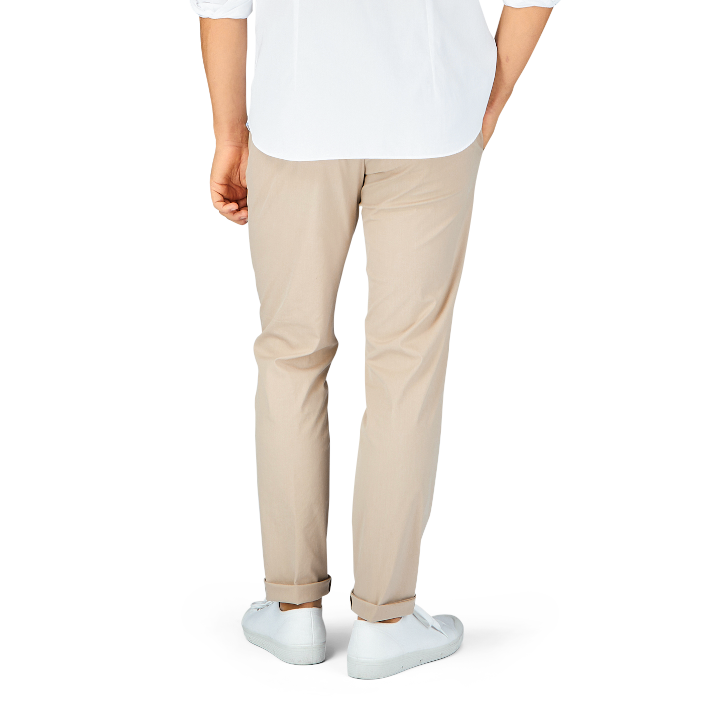 Man standing in a white t-shirt, Hiltl sand beige cotton nylon slim chinos, and white sneakers.