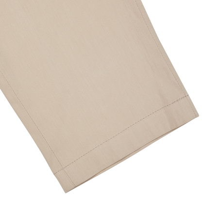A Hiltl sand beige cotton nylon slim chinos with a sand beige cover on a white background.