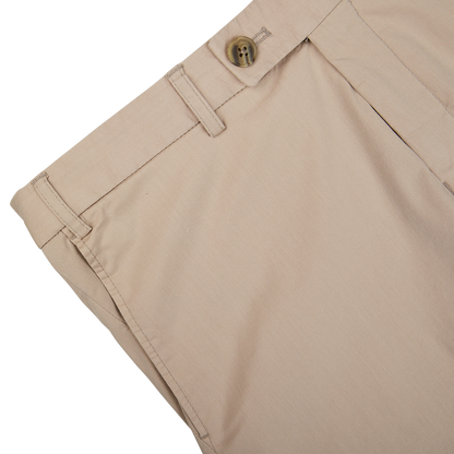 Close-up of Hiltl sand beige cotton nylon slim chinos with a button closure.