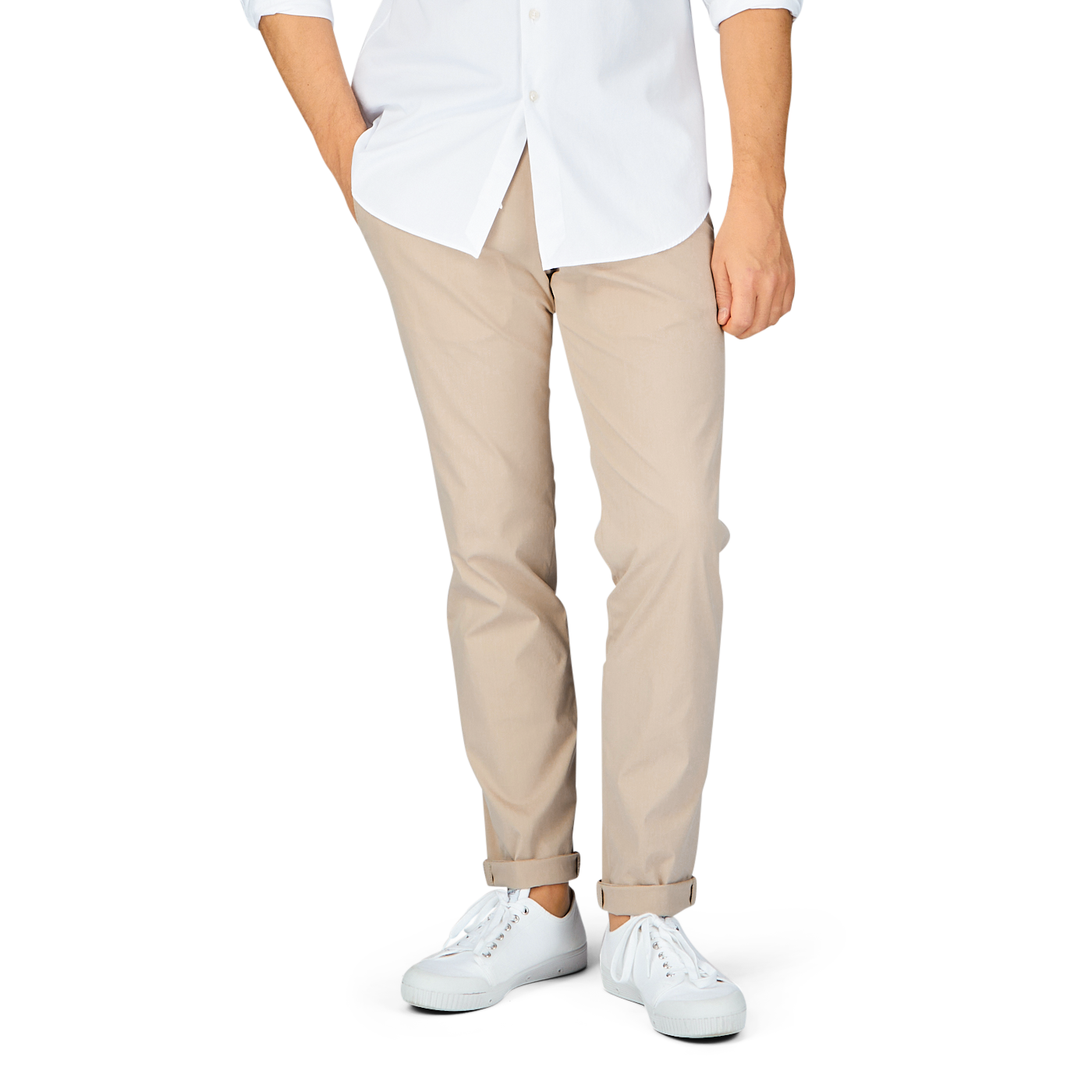 A person standing in a white shirt, Hiltl sand beige cotton nylon slim chinos, and white shoes against a gray background.