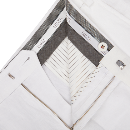 Close-up of a white dress shirt collar and placket details, showcasing buttons, stitching, and inner collar design with Hiltl white washed linen regular fit chinos fabric.