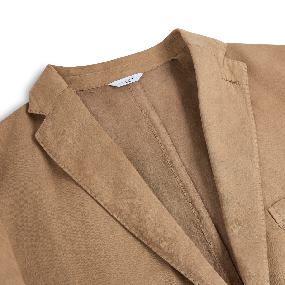 Close-up of the Boglioli Camel Beige Satin Cotton/Linen Jacket, highlighting the lapel, collar, and chest pocket. The fabric appears soft with a slightly worn look, and a white label is sewn into the inside neckline. , available at Richard Gelding Mayfair