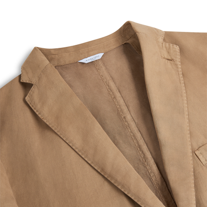 Close-up of the Boglioli Camel Beige Satin Cotton/Linen Jacket, highlighting the lapel, collar, and chest pocket. The fabric appears soft with a slightly worn look, and a white label is sewn into the inside neckline. , available at Richard Gelding Mayfair