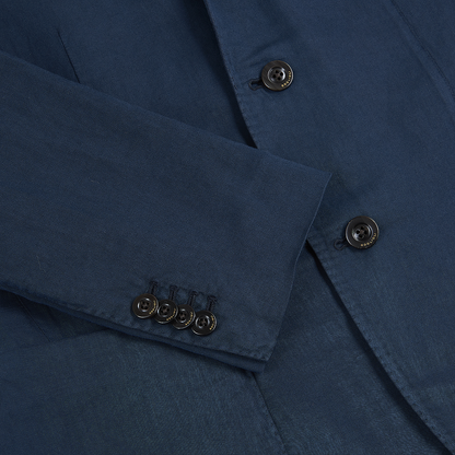 Close-up of a Boglioli Navy Blue Satin Cotton/Linen Jacket, featuring four black cuff buttons and two on the front. The smooth, slightly shiny fabric has visible stitching around the buttons and edges. , available at Richard Gelding Mayfair
