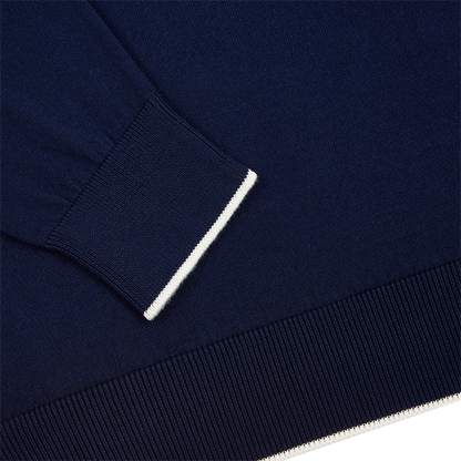 Close-up of Filippo de Laurentiis Navy/White Cotton Cashmere Crew Neck Sweater sleeve and hem, both with ribbed knit. A thin white stripe accents the navy cuff, highlighting the soft, comfortable, and neatly finished design. , available at Richard Gelding Mayfair