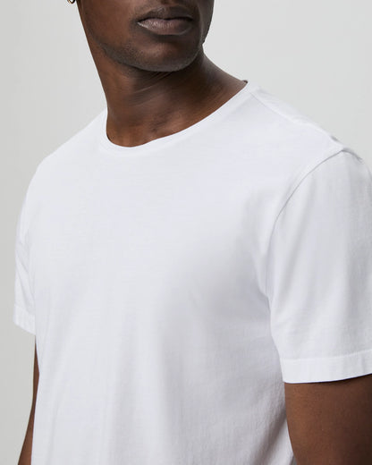 Close-up of a man's torso wearing the Paige White Cotton Sorden Crew Neck T-Shirt, highlighting the shirt's texture and fit against his dark skin. , available at Richard Gelding Mayfair