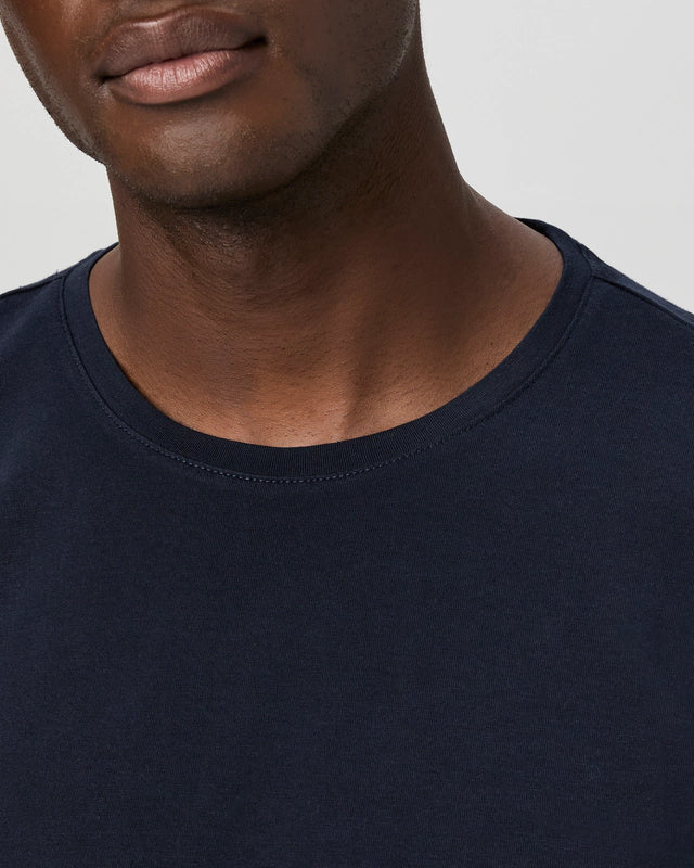 Close-up of a person's neck and collarbone, wearing the Paige Deep Anchor Navy Cotton Sorden Crew Neck. The focus is on the premium fabric and subtle skin texture. , available at Richard Gelding Mayfair