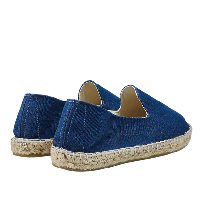 A pair of Dark Jeans San Francisco Denim Espadrilles by Manebi, on a neutral background.