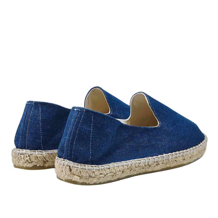 A pair of Dark Jeans San Francisco Denim Espadrilles by Manebi, on a neutral background.