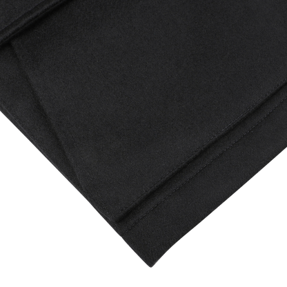 A close-up of neatly folded navy blue cashmere outer fabric with clean edges against a white background, showcasing the Manto Navy Blue Cashmere Car Coat.