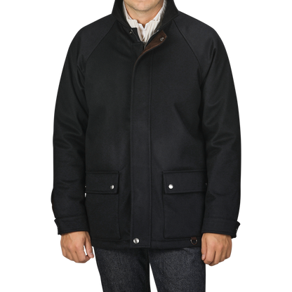 A person wearing a Manto Navy Blue Cashmere Car Coat with buttoned pockets and a striped shirt underneath, photographed from the neck down against a plain background.