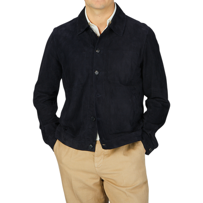 A man wearing a Manto navy blue suede leather overshirt and tan pants.