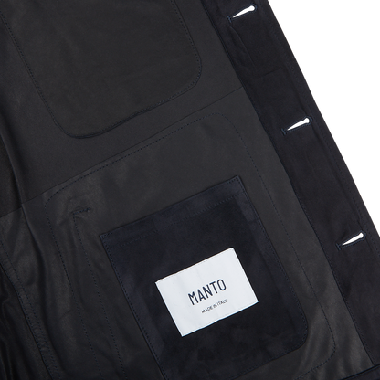 The back of a Manto navy blue suede leather overshirt with a label on it.