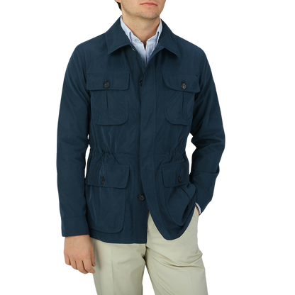 A man wearing a Manto Navy Blue Ultrafine Microfiber Safari Jacket and tan pants.