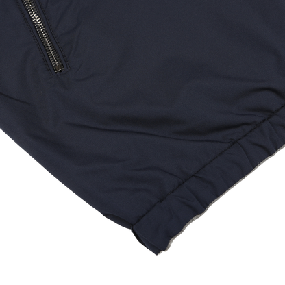 Close-up of the Manto Navy Grey Cashmere Nylon Reversible Blouson, showcasing a zippered pocket and an elasticized hem.
