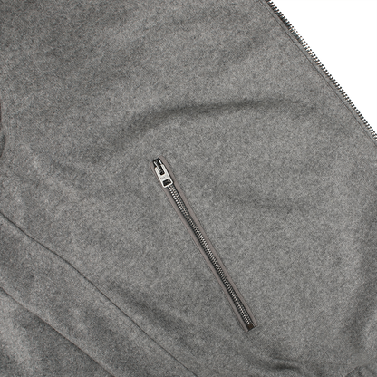 Close-up of the Manto Navy Grey Cashmere Nylon Reversible Blouson, featuring a horizontal zipper pocket and crafted from water-resistant gray nylon.