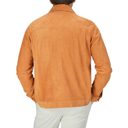 The back view of a man wearing a Manto Bright Tan Suede Leather Overshirt.