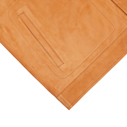 A Bright Tan Suede Leather Overshirt by Manto on a white surface.