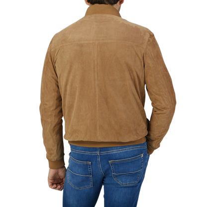A man wearing a Tobacco Brown Perforated Suede Leather Blouson by Manto.