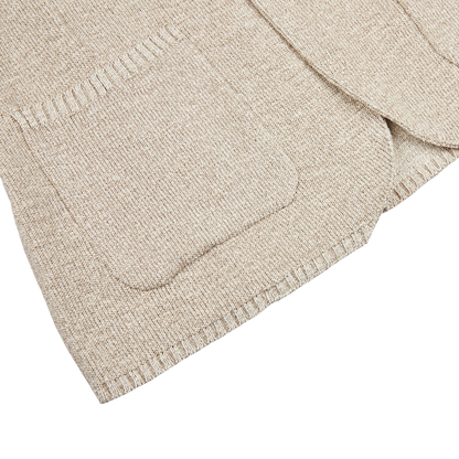 A Beige Melange Cotton Mouline Knitted Jacket by Maurizio Baldassari with a pocket on the front.