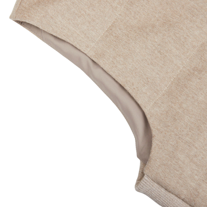 A close up of Maurizio Baldassari's Beige Water Repellent Pure Cashmere Gilet on a white surface.