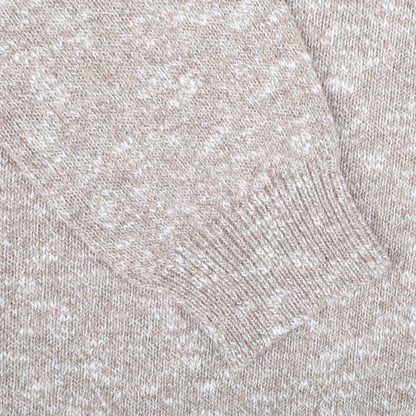 Close-up of the Beige Winter Wool Mouline 1/4 Zip Sweater sleeve by Maurizio Baldassari, showcasing the ribbed cuff detail of this soft wool-cotton blend piece.