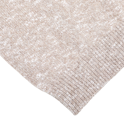 Close-up of the Beige Winter Wool Mouline 1/4 Zip Sweater by Maurizio Baldassari, showcasing a light beige knitted fabric with a ribbed edge and an intricate textured pattern, reminiscent of oatmeal beige melange.