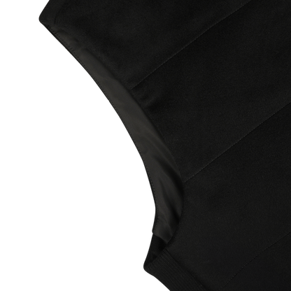 Close-up of a black water repellent cashmere gilet by Maurizio Baldassari, showcasing its texture and seam details. The image focuses on the upper left section of the garment.
