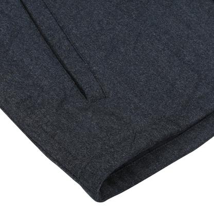 Close-up of the Blue Melange Quilted Virgin Wool Overshirt by Maurizio Baldassari, showcasing its subtle texture, a seam, and a small vertical opening.