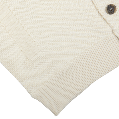 Close-up Maurizio Baldassari Cream Beige Silk Cotton Knitted Blouson with ribbed cuffs and a button detail.