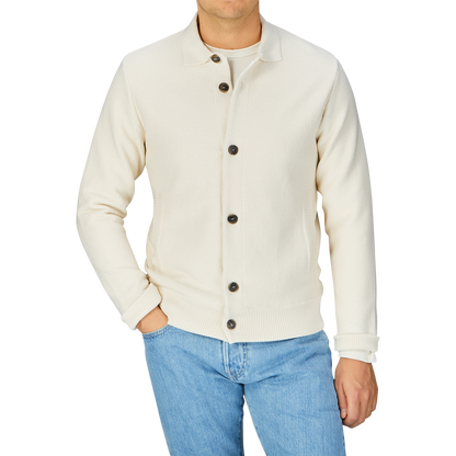 Man wearing a Maurizio Baldassari Cream Beige Silk Cotton Knitted Blouson and blue jeans.