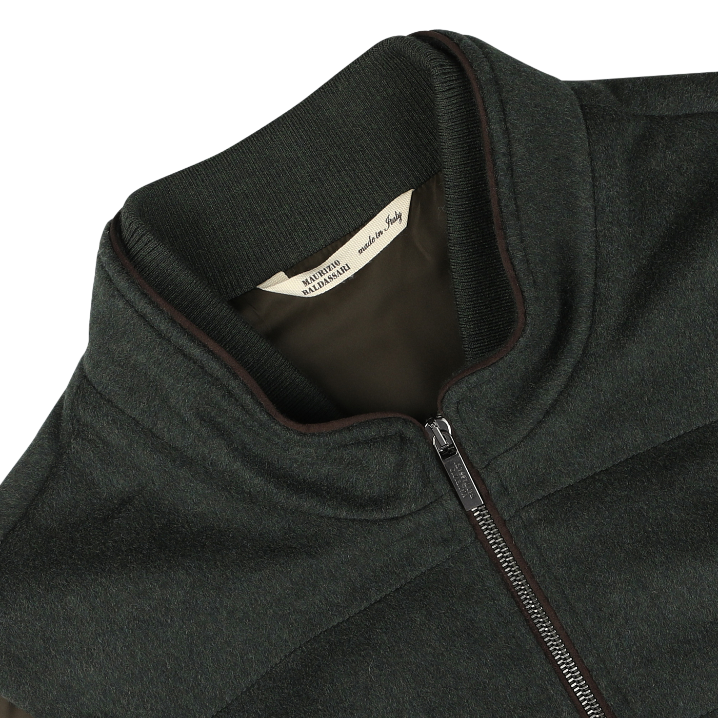 Close-up of a dark green water-repellent cashmere gilet with a ribbed collar, labeled "Maurizio Baldassari" inside, made from 100% cashmere.