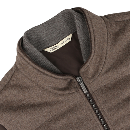 Close-up of a Dark Taupe Water Repellent Cashmere Gilet by Maurizio Baldassari, featuring a high collar and a label that reads "Made in Italy.