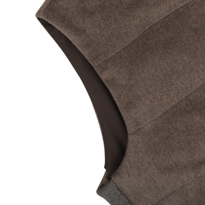 Close-up of the armhole and shoulder of the Dark Taupe Water Repellent Cashmere Gilet by Maurizio Baldassari on a light background.
