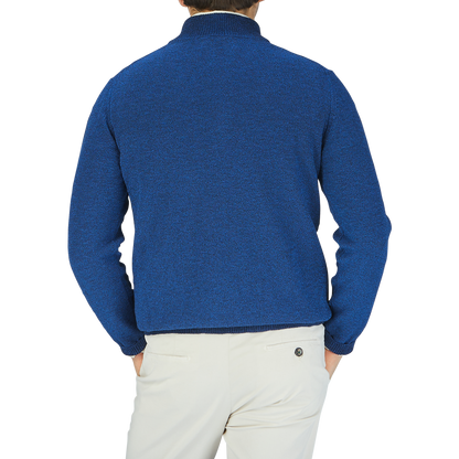 The back view of a man wearing a Maurizio Baldassari Denim Blue Cotton Mouline 1/4 Zip Sweater.